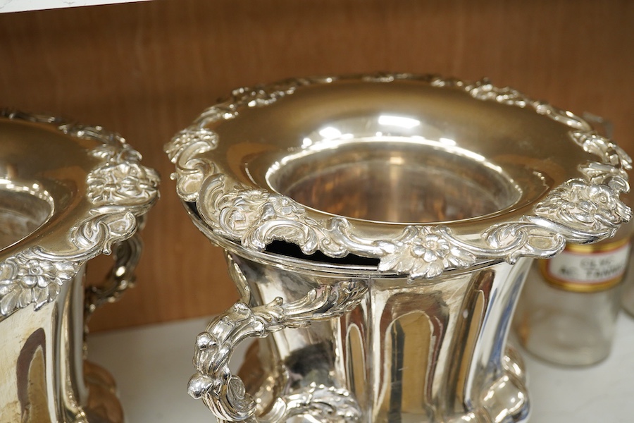 A pair of Old Sheffield plate two handled plated wine coolers, with later associated liners, 26cm high. Condition - fair